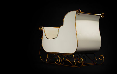 White bodied sleigh that is a Christmas decoration on a black background.の写真素材