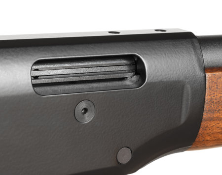 Hole that ejects empty shells on a lever action with with the bolt showing on the wood stocked gun isolated on a white backgrou.nd.の写真素材