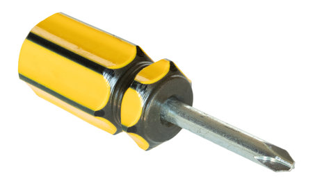 Short screwdriver seen at an angle that has a yellow and black grip and a head used to work on screws with a cross shape in their grooves isolated on a white background.の写真素材