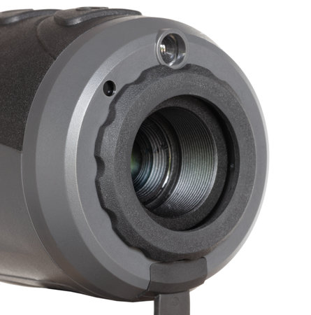 Close-up of the objective lens with thermal LED emitter on top of a night vision monocular isolated on a crisp white background.の写真素材