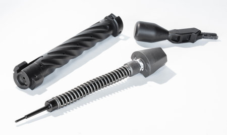 Isolated high powered centerfire rifle bolt in three pieces on a white background with shadow underneath.の写真素材