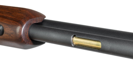 Brass looking cover on the loading port for a lever action rifle that has a wood stock isolated on a white background.の写真素材
