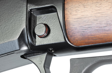 Crossbolt safety on a lever action rifle that has red showing, which indicates it it ready to fire and isolated on a white background.の写真素材