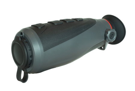 Optic that allows vision in the night that is small enough for handheld use as a monocular isolated on a crisp white background.の写真素材