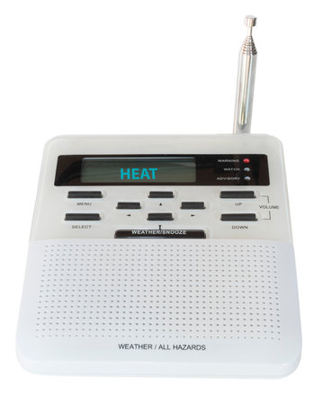 Radio designed to digitally receive and sound an alarm with for hazards and weather showing a heat warning issued for the immediate area.の写真素材