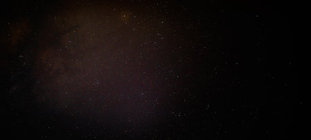 Red cluster of stars and dust in the dark sky over North Carolina with light shining through brightly .の写真素材
