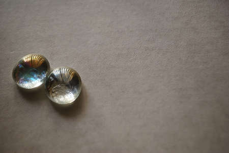 Two glass round stones on solid background の写真素材