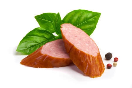 Smoked sausages with basil and spices, isolated on white backgroundの写真素材