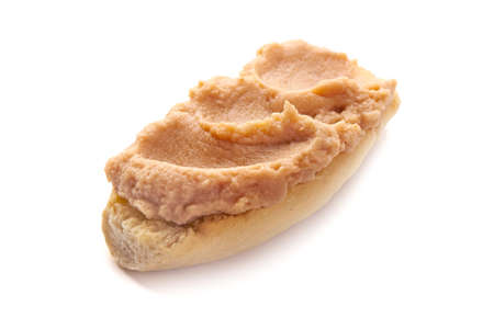 Fish pate on bread, isolated on white background.の写真素材
