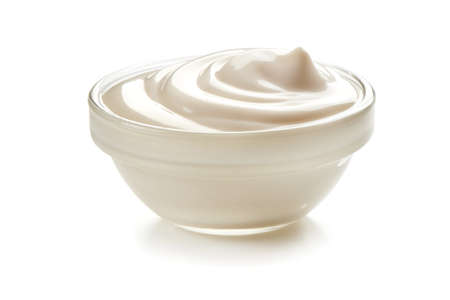 Bowl of sour cream, isolated on white background.の写真素材
