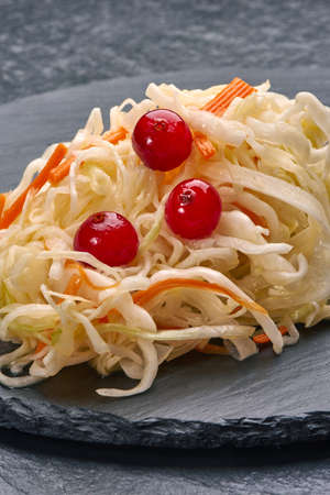 Cabbage salad with carrots on stone plateの写真素材