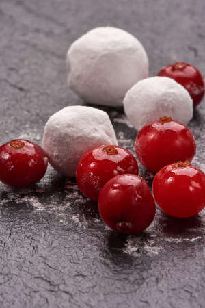 Cranberry in sugar on black stone boardの写真素材