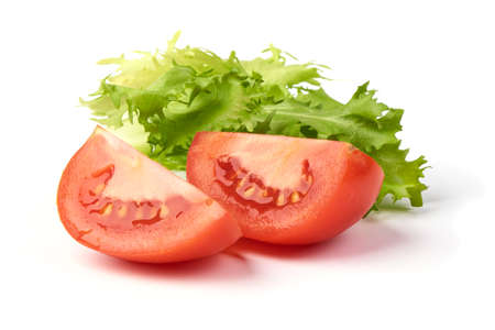 Slice tomato with green fresh salad, isolated on white background.の写真素材
