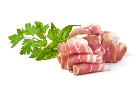 Twisted pieces of pork farmer meat or bacon with parsley, isolated on white backgroundの写真素材