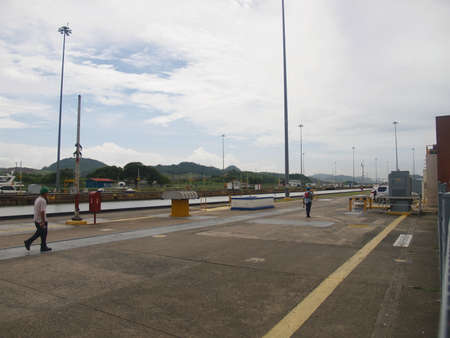 Two workers walk through the Miraflores canal, Panama.のeditorial素材