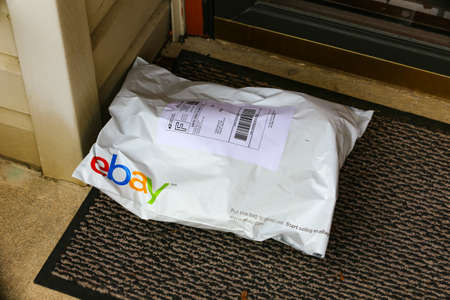 Lancaster, PA, USA - December 4, 2017: An ebay pack delivered at a front residential door.のeditorial素材