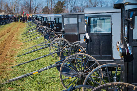 Gordonville, PA, USA - March 10, 2018: Buggies in a muddy field ready to be sold at the annual Lancaster County Mud Sale at the Gordonville Fire Company.のeditorial素材