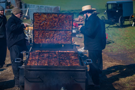 Gordonville, PA, USA - March 10, 2018: Volunteers cook chicken at the annual Lancaster County Mud Sale at the Gordonville Fire Company.のeditorial素材