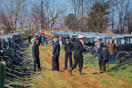 Gordonville, PA, USA - March 10, 2018: Potential bidders look over Amish buggies to be auctioned at the annual Lancaster County Mud Sale at the Gordonville Fire Company.のeditorial素材