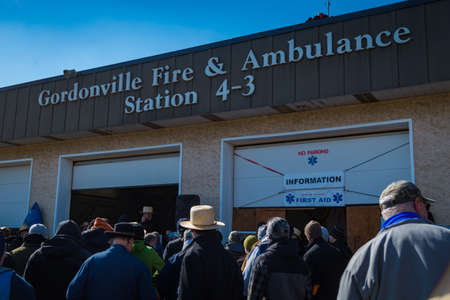 Gordonville, PA, USA - March 10, 2018: An Amish selling items at the fire station at the annual Lancaster County Mud Sale at the Gordonville Fire Company.のeditorial素材