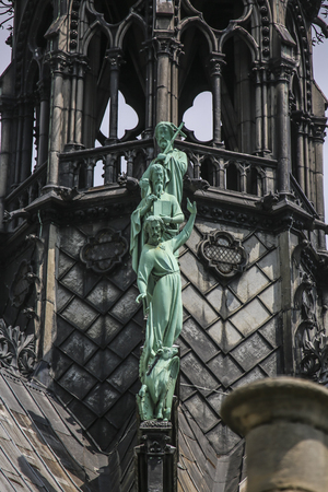 Three statues on facade sprear of Notre Dame of Paris, Franceの写真素材