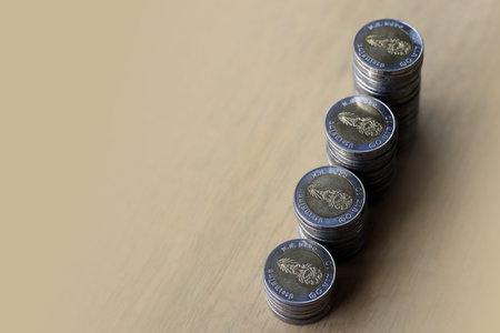 Thai bath coin money put together near the window, natural lighting.
