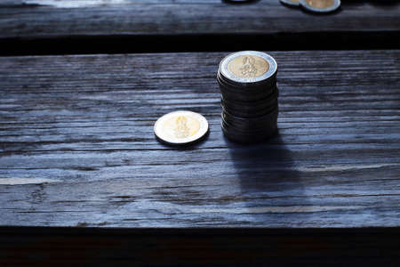 money stack is put together on old wood backgroundの写真素材