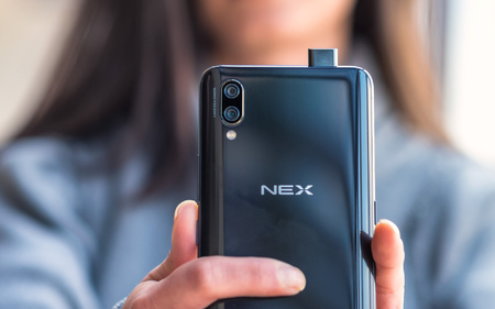 A women holding a Vivo NEX smartphone (seen from the back) with retractable front camera and dual main cameraのeditorial素材