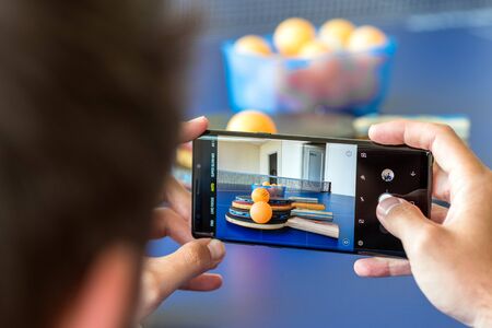 Man capturing a photo with Galaxy Note9のeditorial素材