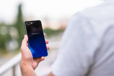 Man holding the Oppo F9 smartphone in handのeditorial素材