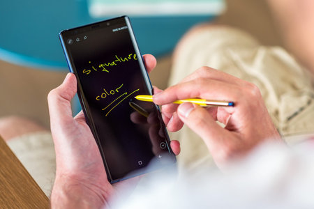 Man typing on a Samsung Galaxy Note9 smartphone