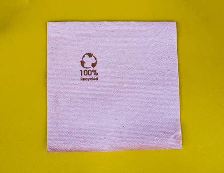 Ecological napkin on a yellow table. Environmentalism concept.の写真素材
