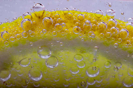Slice Of Lemon In Mineral Water Bubblesの写真素材