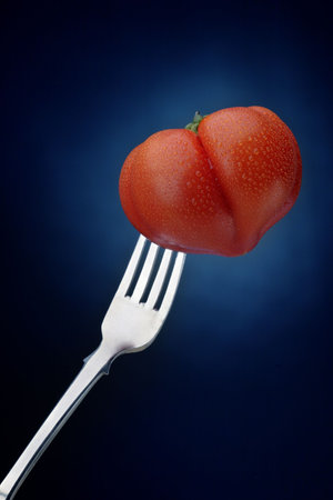 Tomato and forkの写真素材
