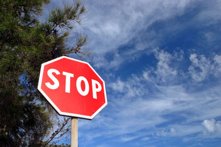 Stop Sign framed against blue dramatic skyの写真素材