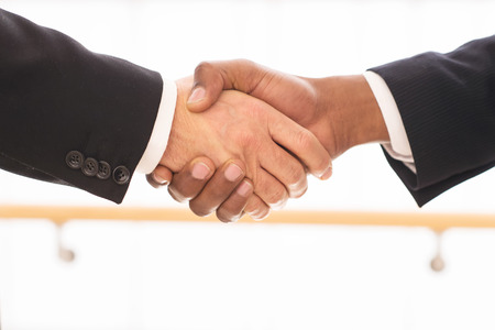 Sealing a deal. Close-up of business men shaking handsの写真素材
