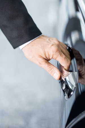Opening car. Close-up of hand holding the car handleの写真素材