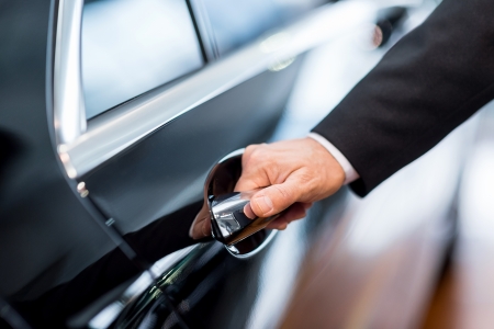 Hand on handle. Close-up of man in formalwear opening a car door の写真素材