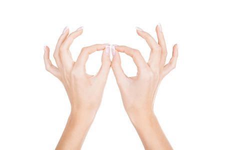 Beautiful female hands  Close-up of female hands gesturing while isolated on white backgroundの写真素材