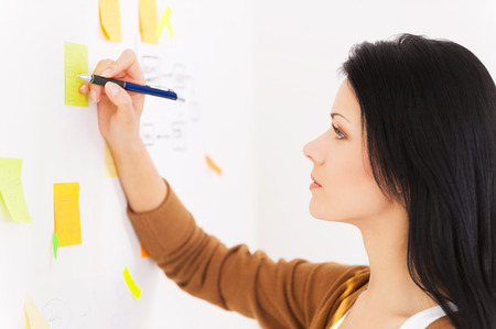 My reminder  Smiling women writing on adhesive papersの写真素材