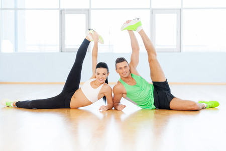 Sporty couple exercising at the fitness gymの写真素材