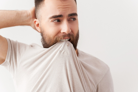 Young and confident. Portrait of handsome young man in t-shirt posing  の写真素材