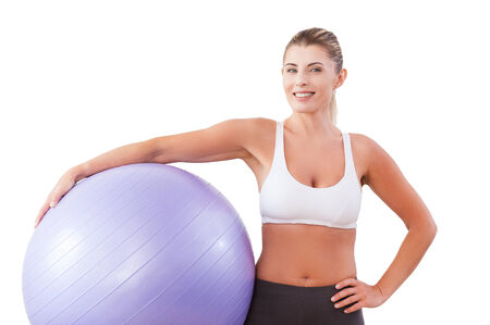 Beauty with exercise ball. Beautiful mature woman holding fitness ball and smiling at camera の写真素材