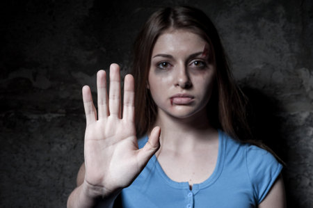 Stop hurting woman  Young beaten up woman looking at camera and stretching out hand while standing...