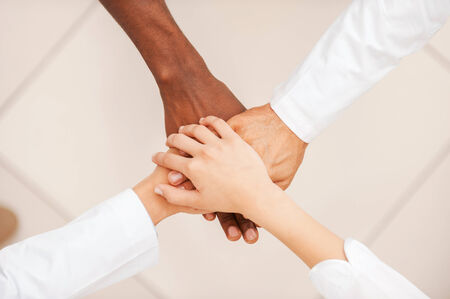 Top view of doctors team holding their hands togetherの写真素材