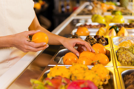 Choosing the freshest fruits. Close-up of woman choosing fruits in grocery storeの写真素材