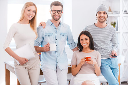 Successful creative team. Group of business people in smart casual wear looking at camera and...