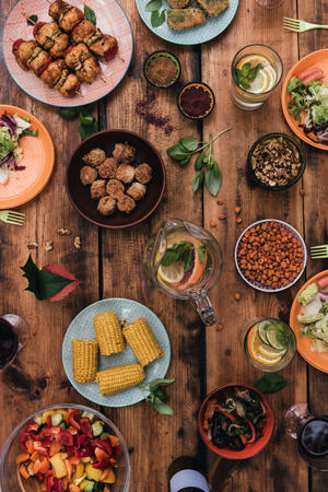 Enjoy your dinner! Top view of food and drinks on the rustic wooden table Enjoy your dinner! Top view of food and drinks on the rustic wooden table