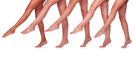 Beautiful legs. Close-up of five beautiful women stretching out their perfect legs while standing...