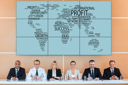 International conference. Group of business people looking at camera with smile while sitting at the...